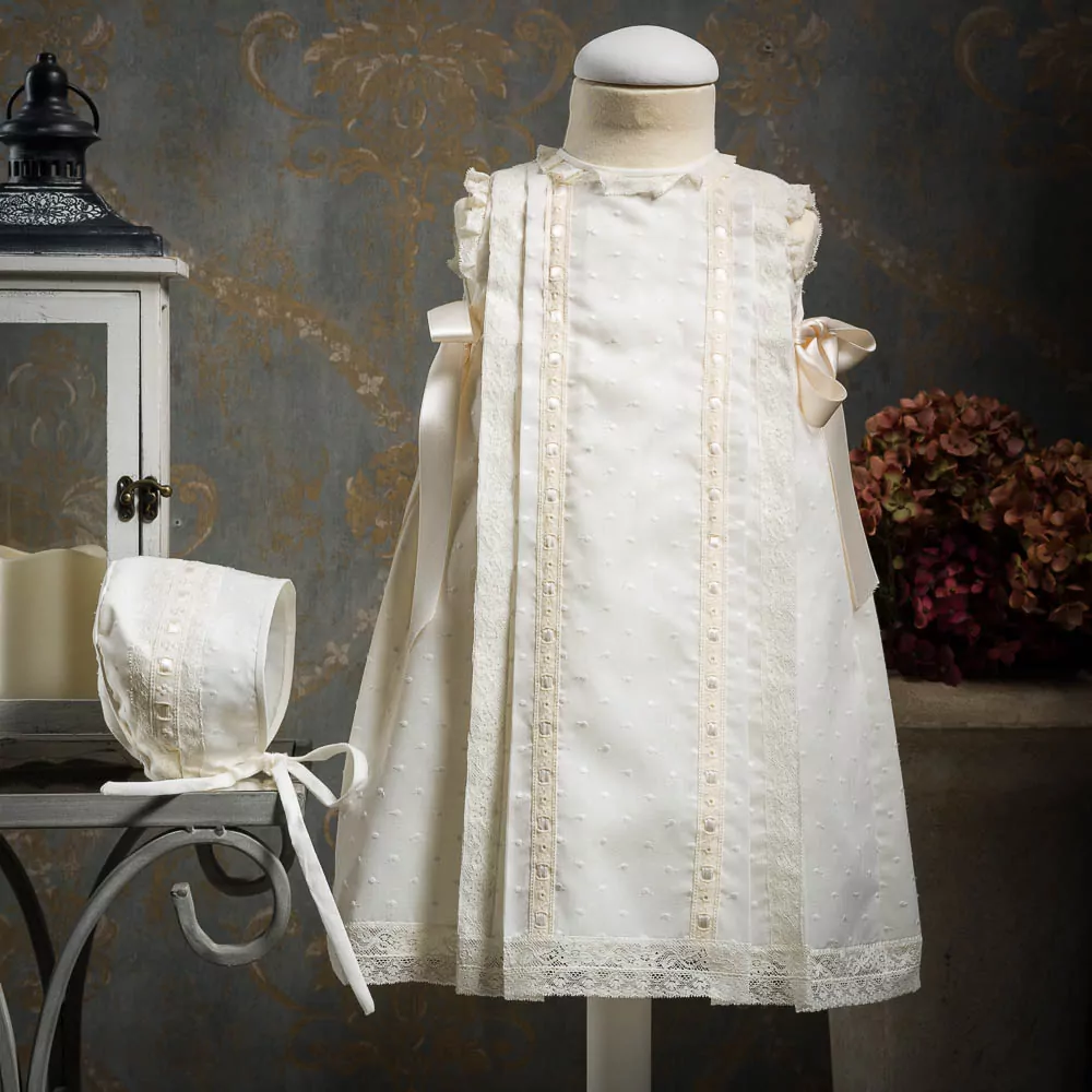 Embroidered batiste cotton dress with lace and satin ribbon bows